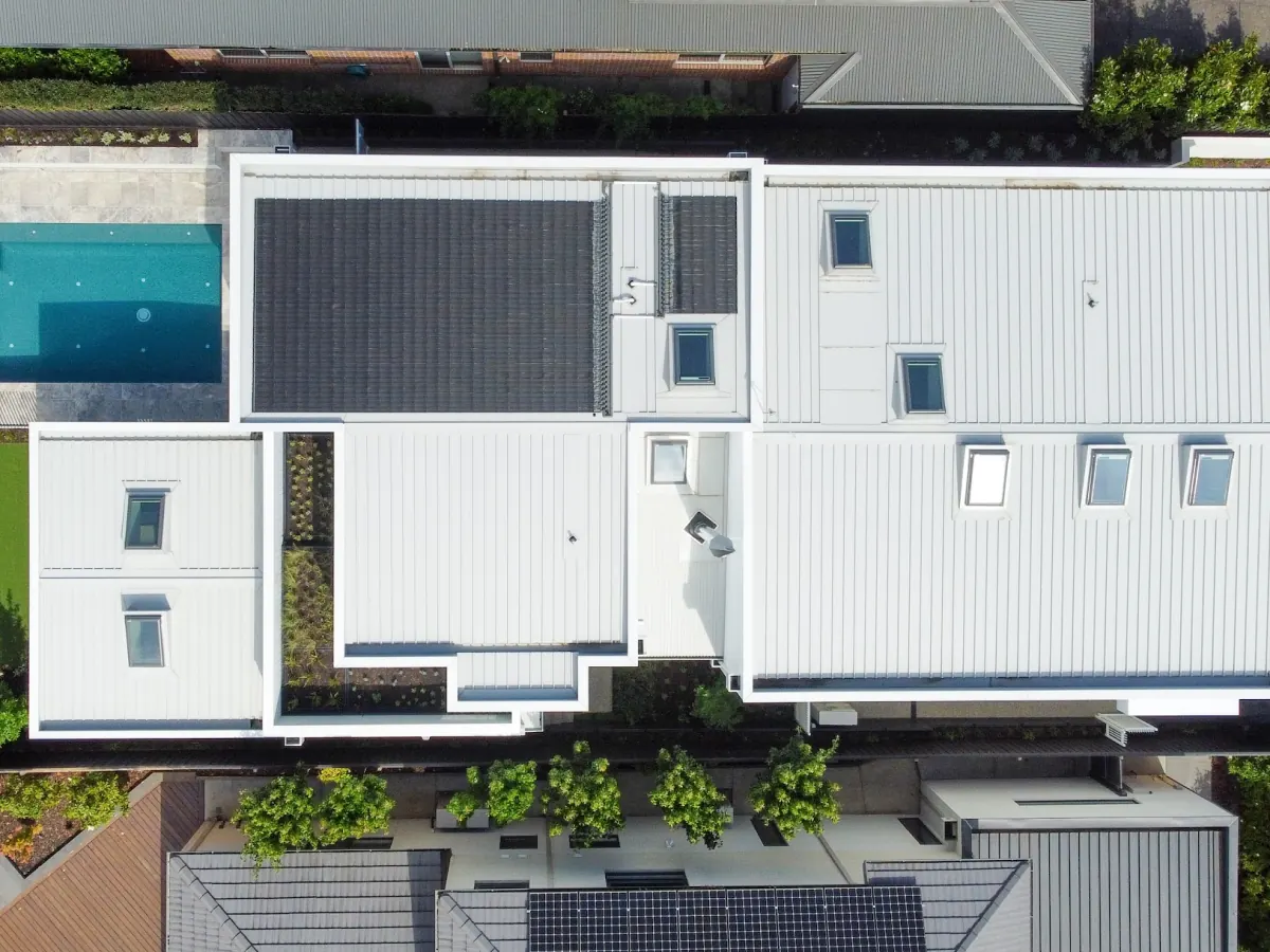 Aerial view of the same site with the finished home
